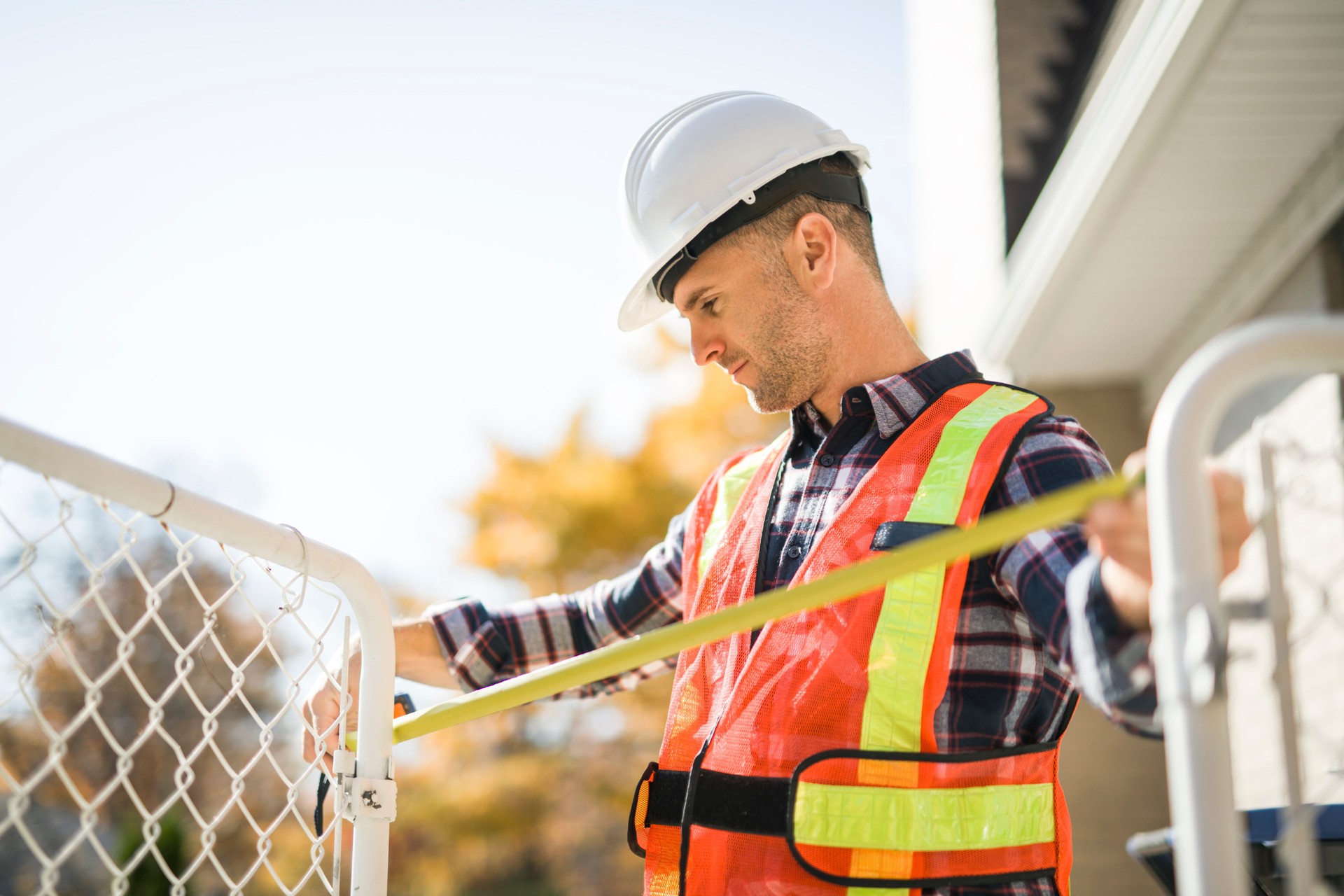 Safety fence at swimmimg pool with worker inspection men